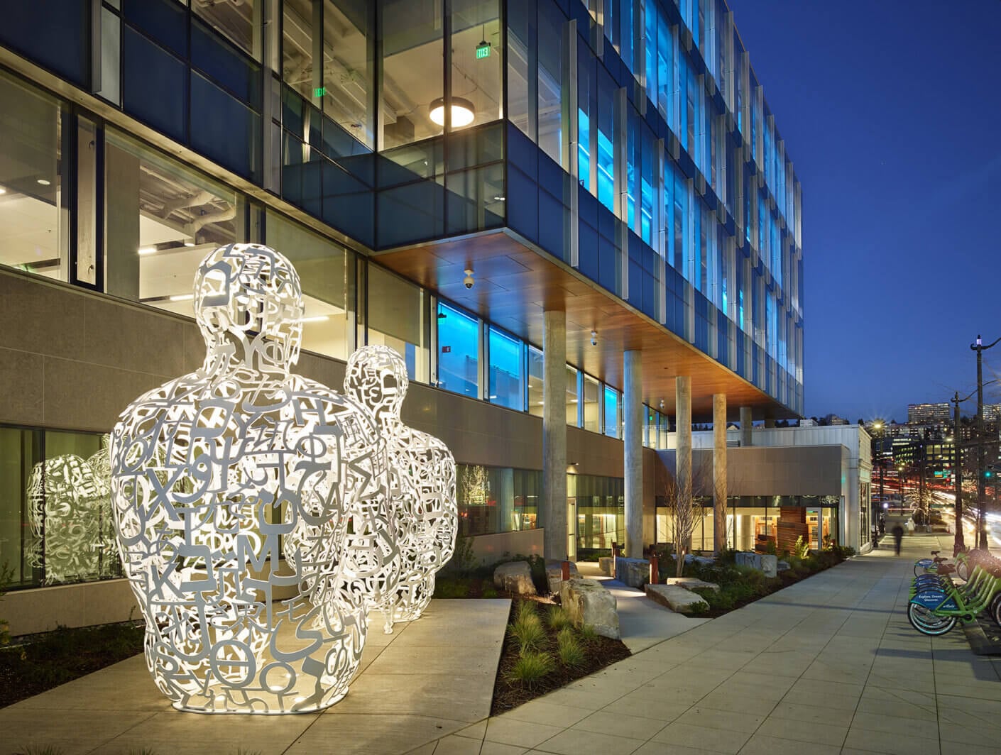 Abstract sculptures of two people outside the Allen Institute