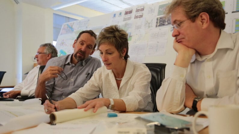 Kay Kornovich sketching concepts with three men