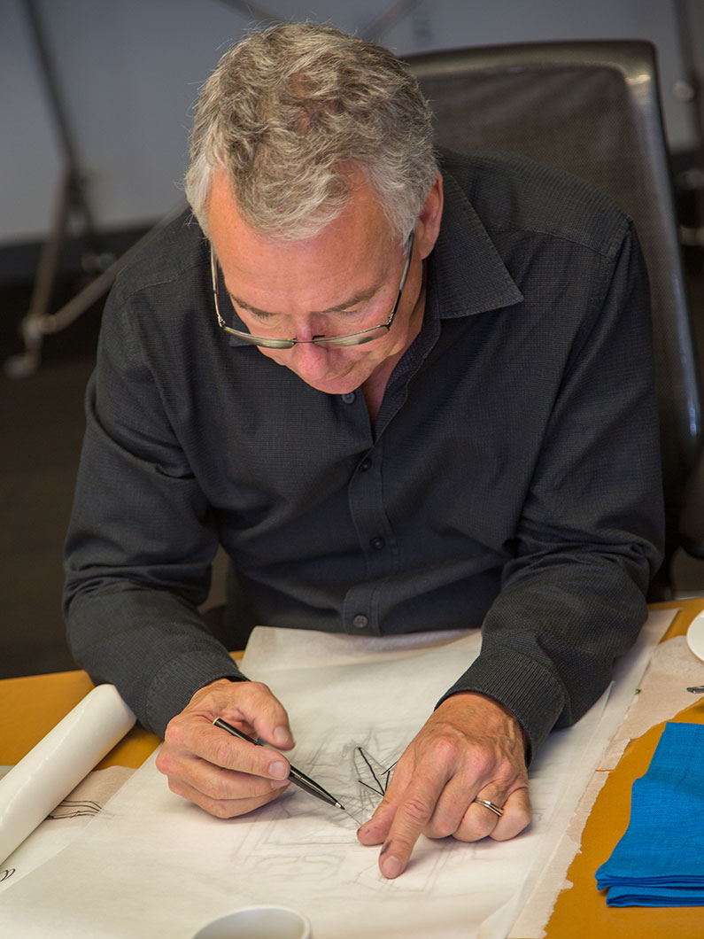 Peter Busby sketching over a drawing.