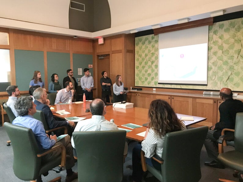 Interns presenting to City officials.