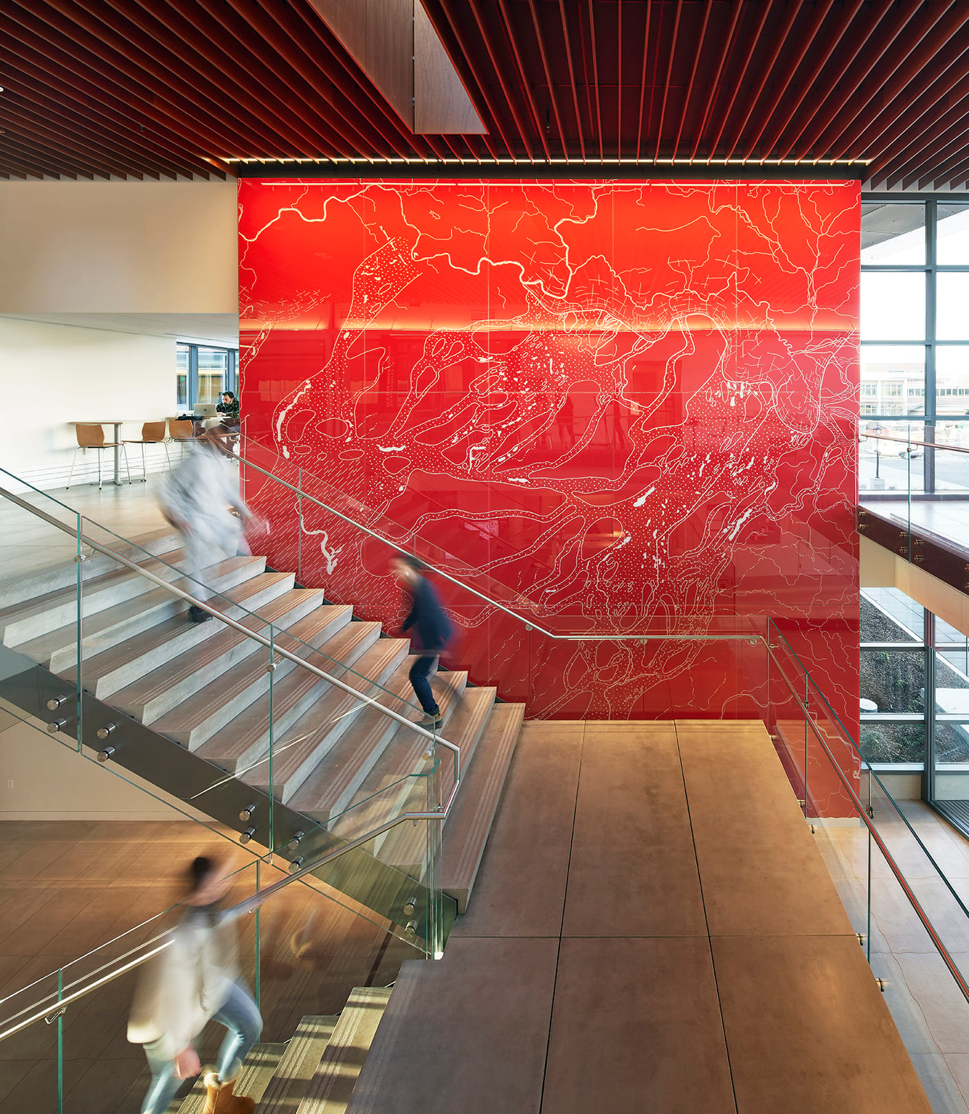 Red glass feature wall with abstracted map of local topography