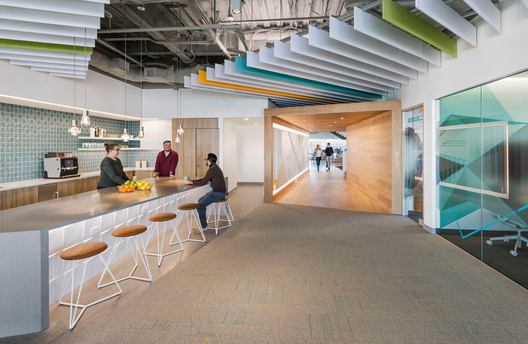 Cafe space with people gathering and hallway with people walking down