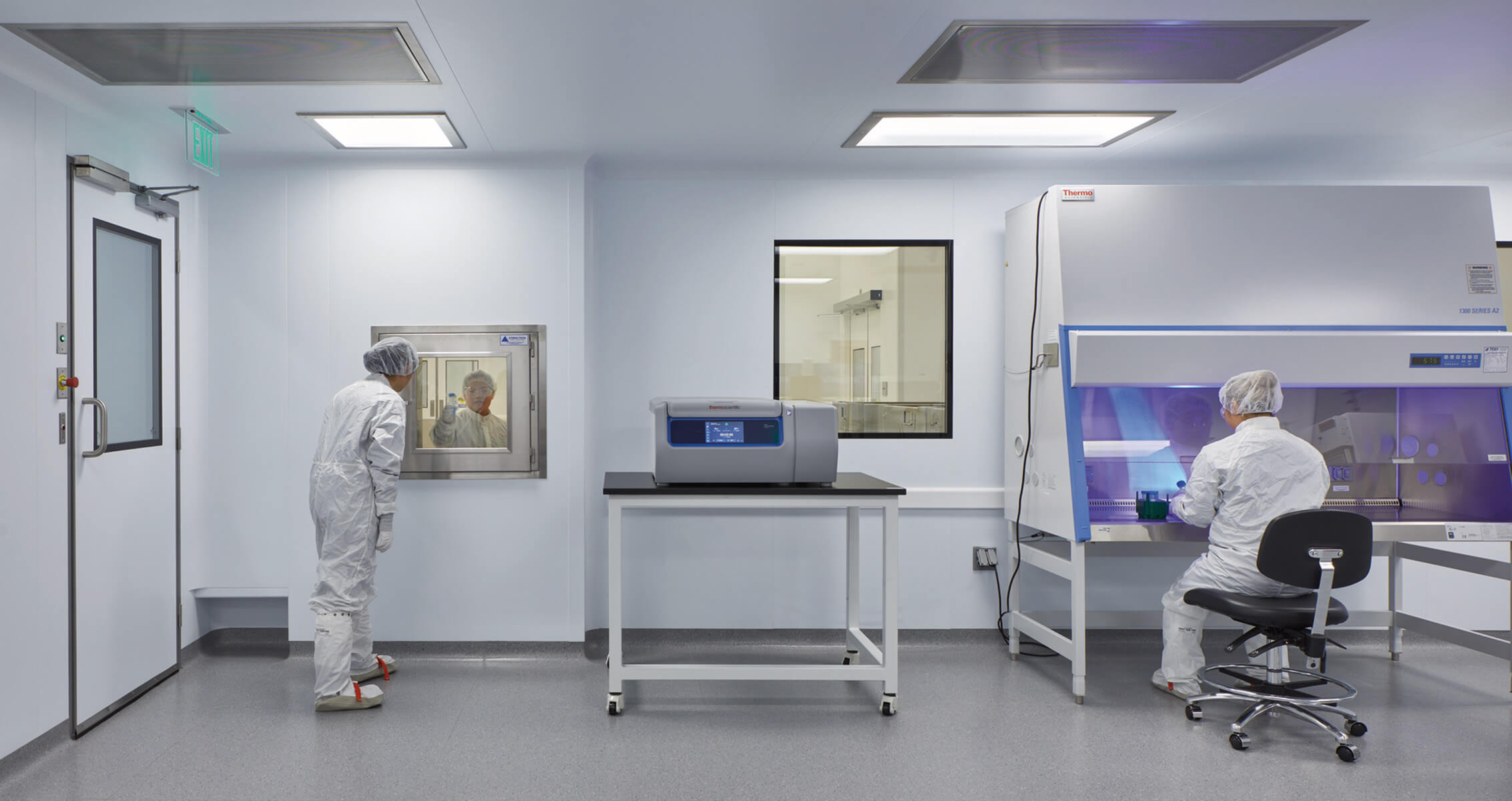 cGMP lab space with people working in full PPE