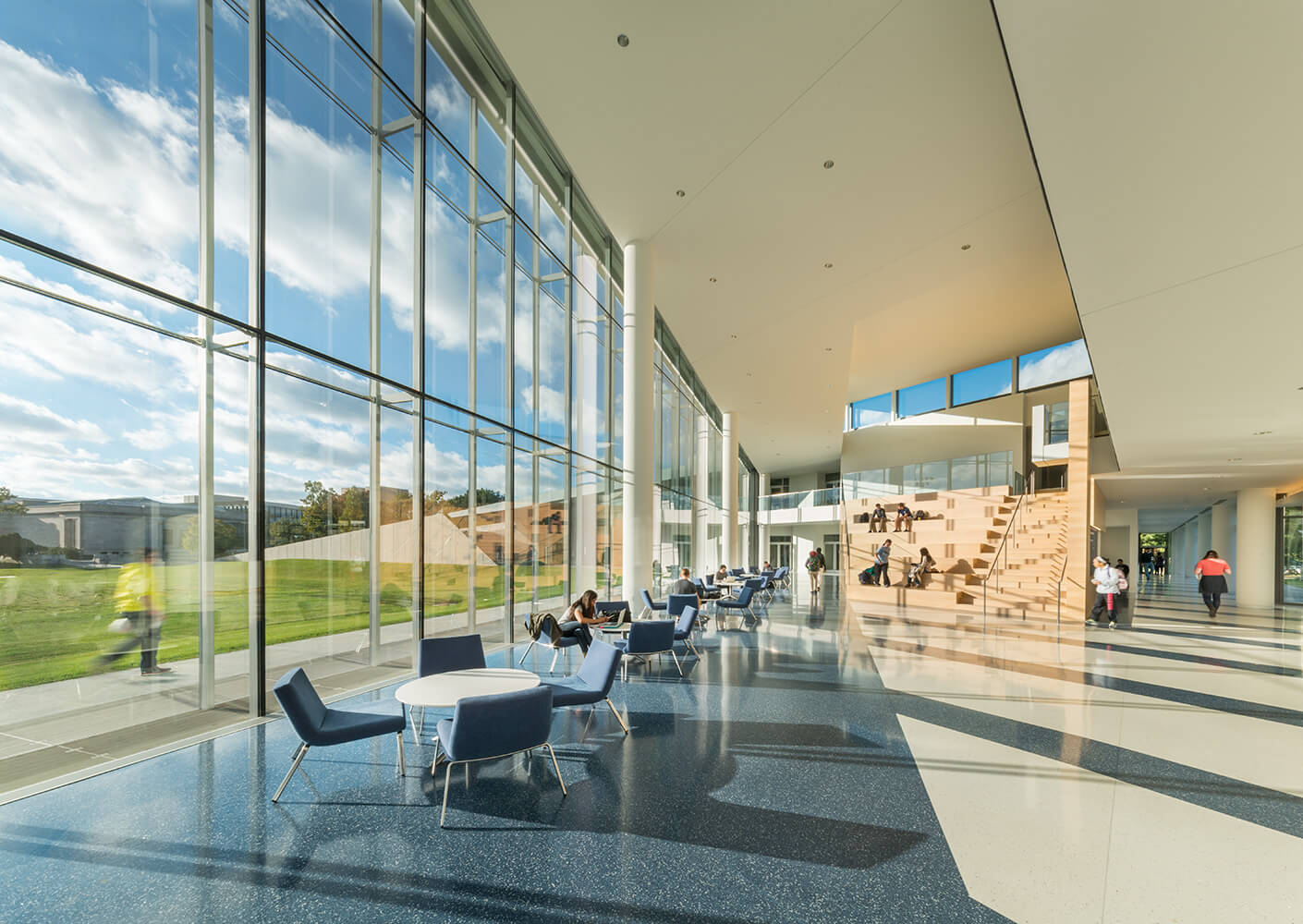 Photograph of interior view through glass curtain wall onto the landscape