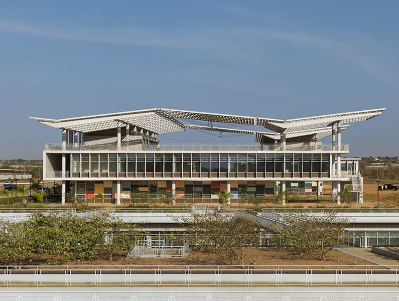 Elevation view photograph of building and landscape of Universidade Agostinho Neto in Luanda, Angola