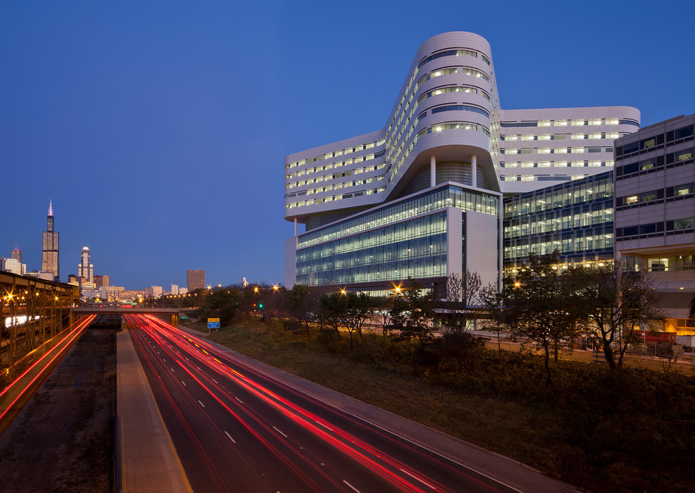 Photograph view from the Eisenhower Expressway looking up at the Rush University Medical Center square base and butterfly tower