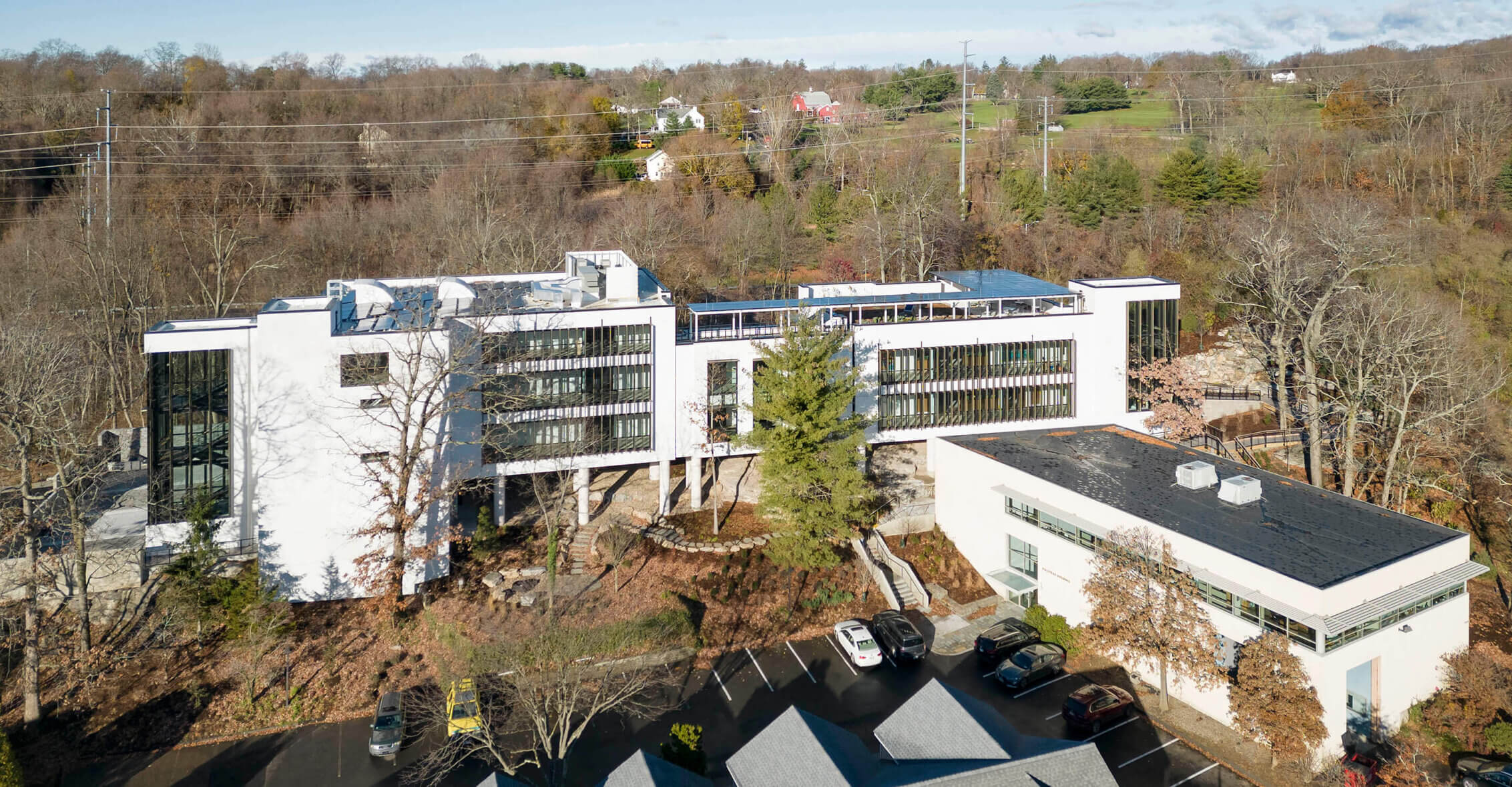 Photo of sustainable corporate headquarters in late autumn with solar panels and green roof