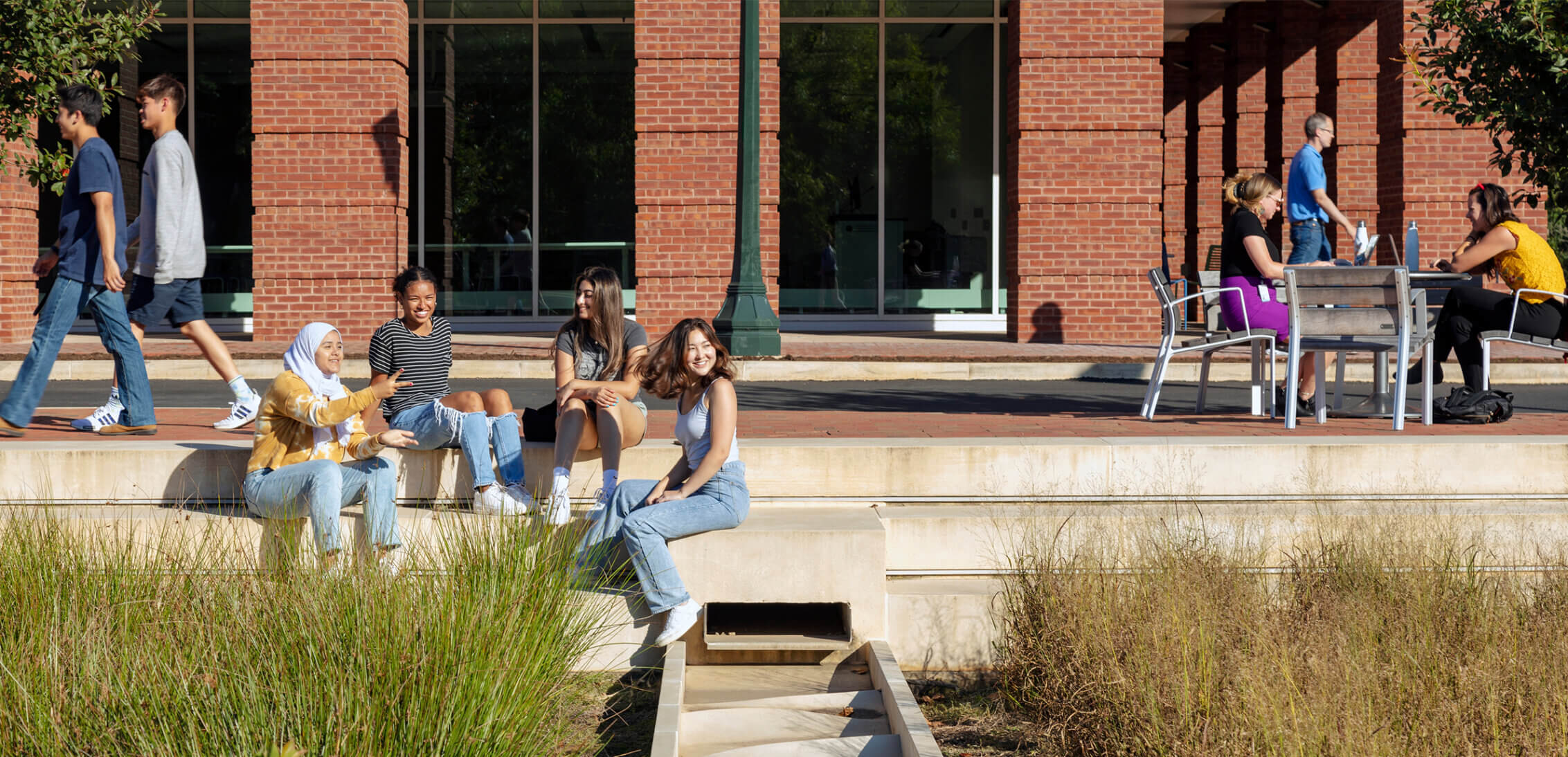 Students sitting among the landscape at the University of Virginia.