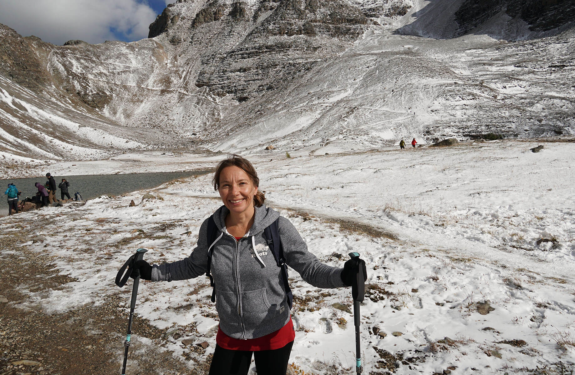 a person posing with hiking poles on a snowy field
