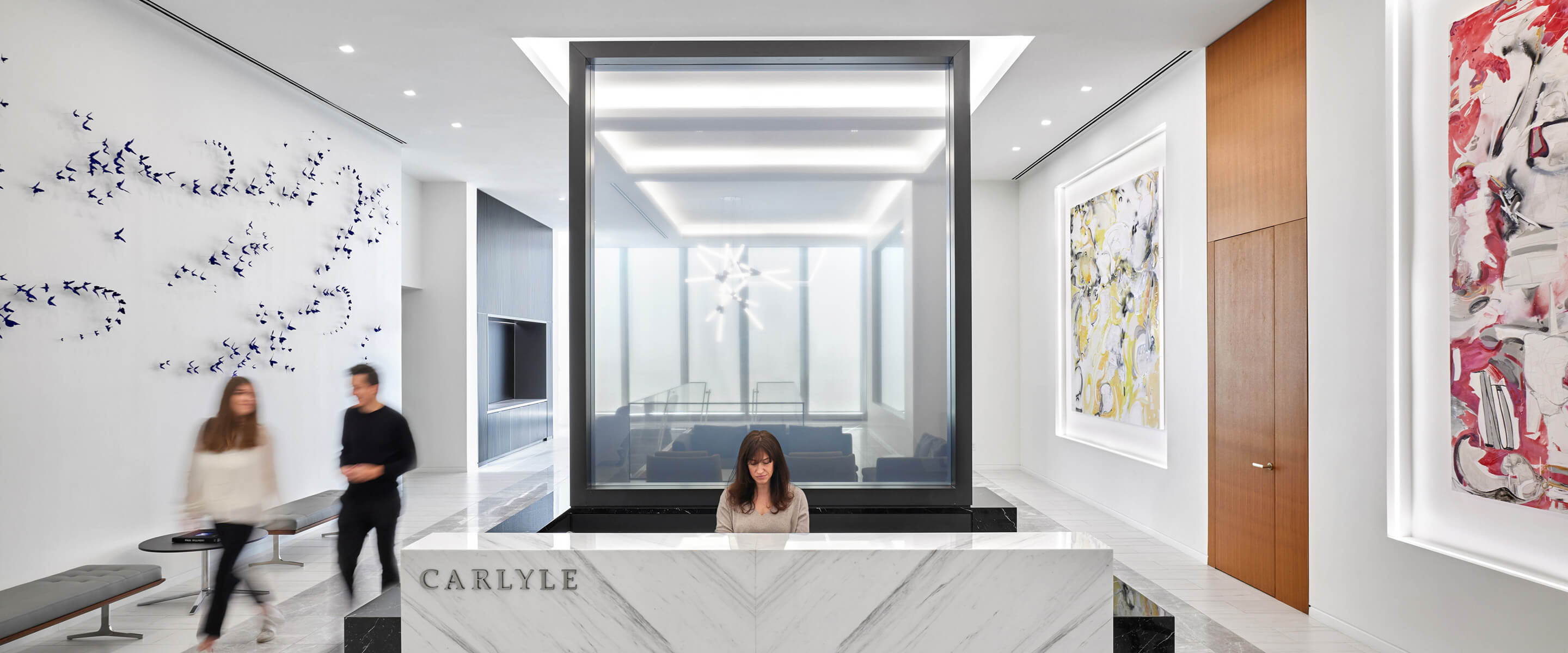 Entry area of office with person sitting at front desk