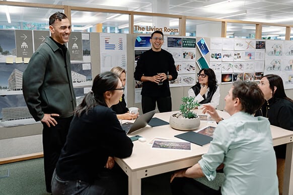Team brainstorming session in modern office with presentation boards.