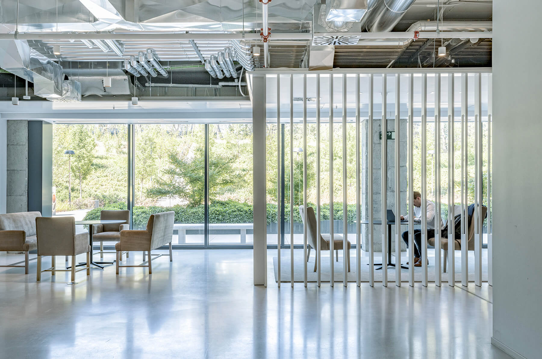 Modern office space with seating and large windows.