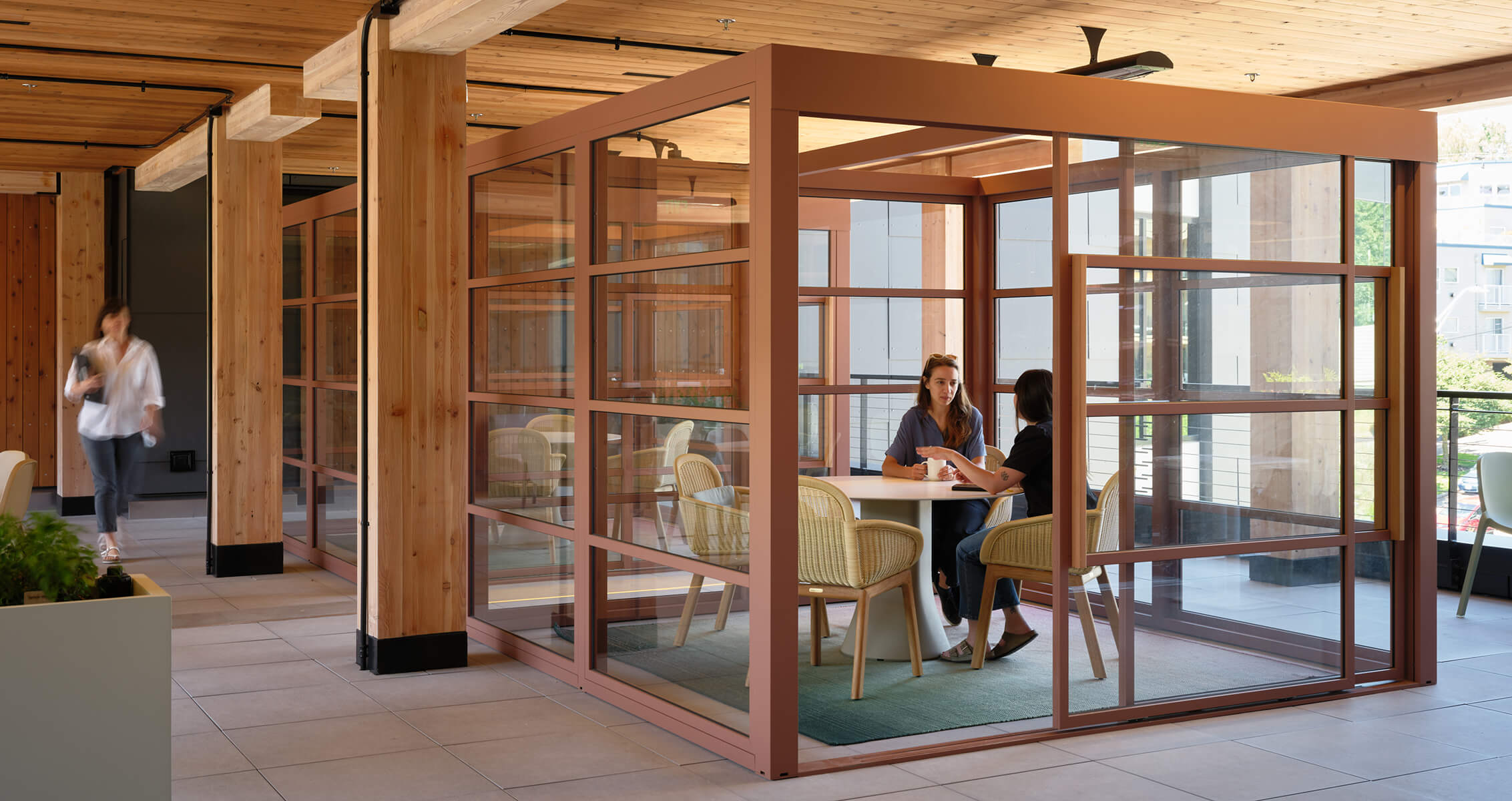 Modern office meeting space with wood accents and glass walls.