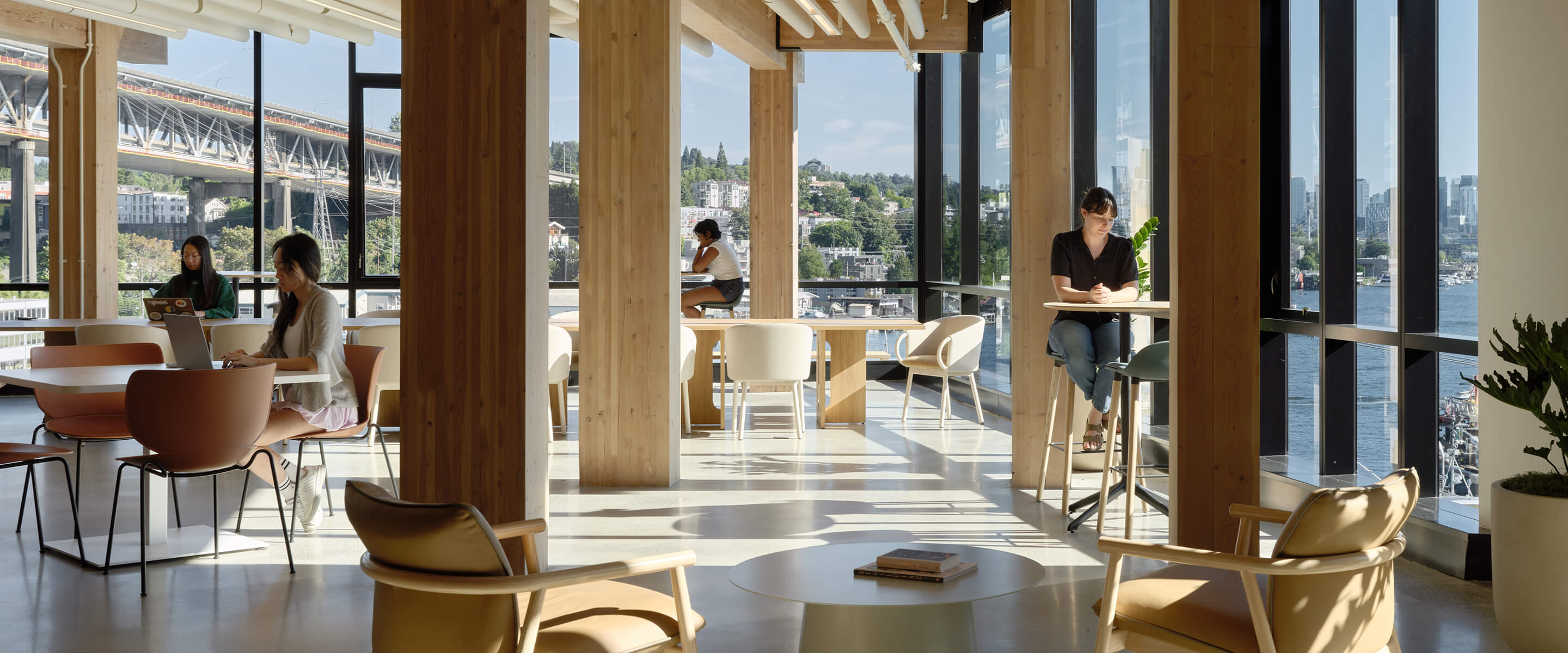 Modern coworking space with large windows and view of the city and river.
