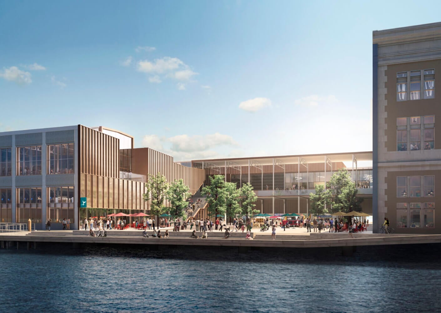 Modern waterfront building with people gathering outside under a clear blue sky.