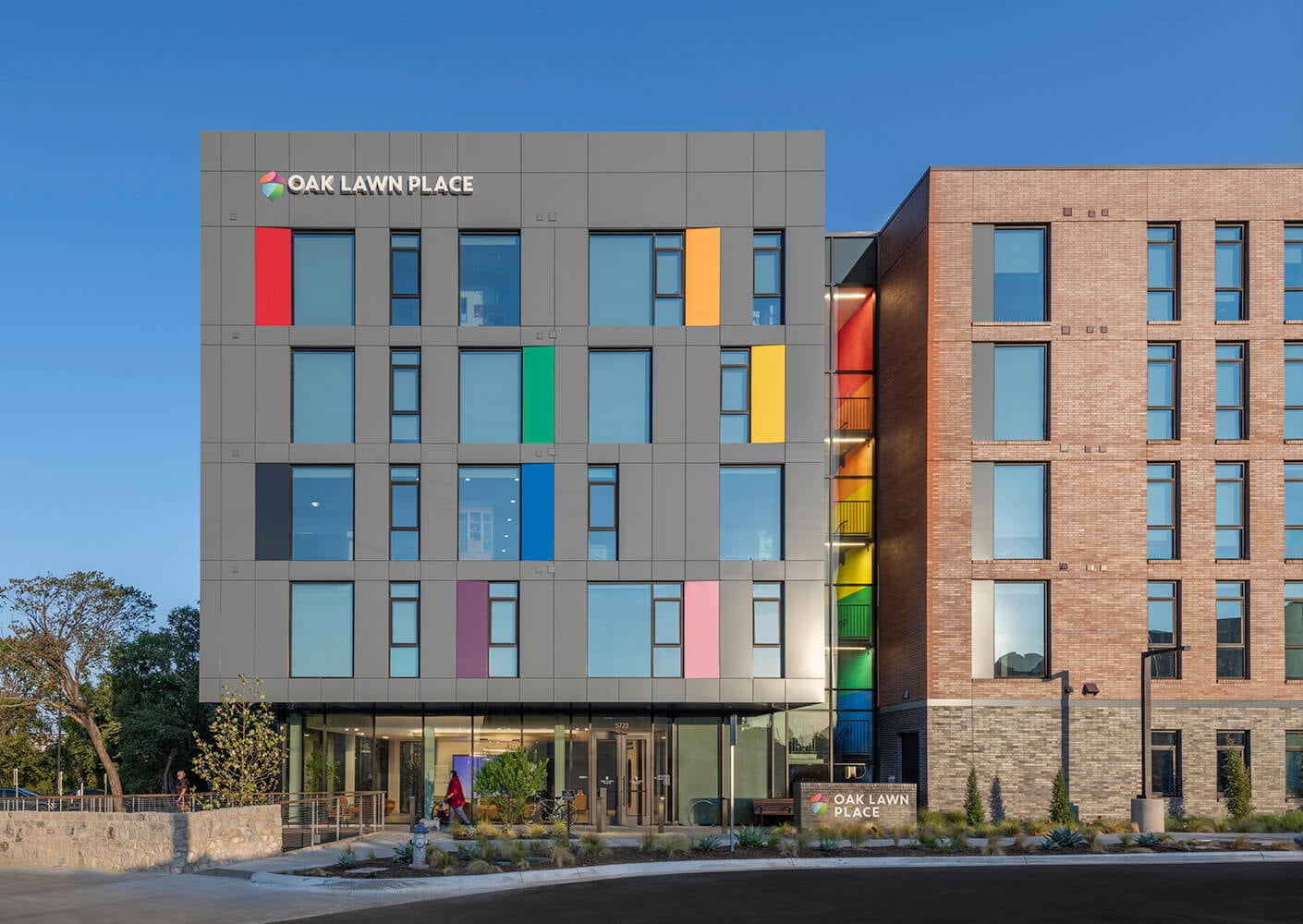 Modern building facade with colorful panels and large windows.