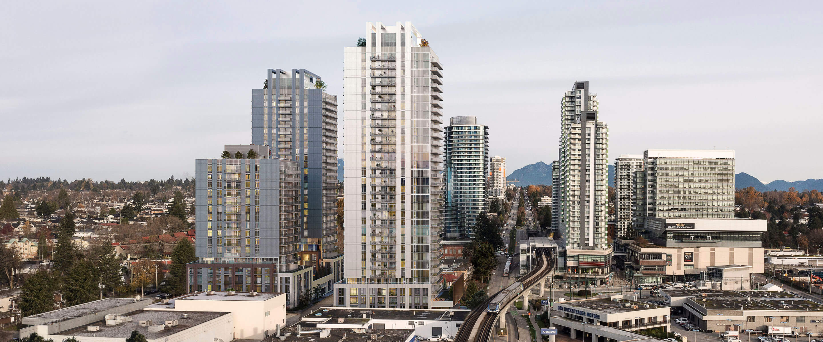 Urban skyline with modern skyscrapers and transit line under a clear sky.