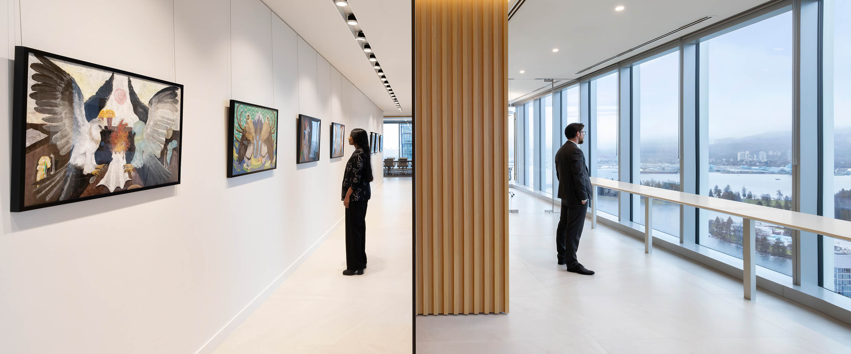 Office art gallery and city view through large windows.