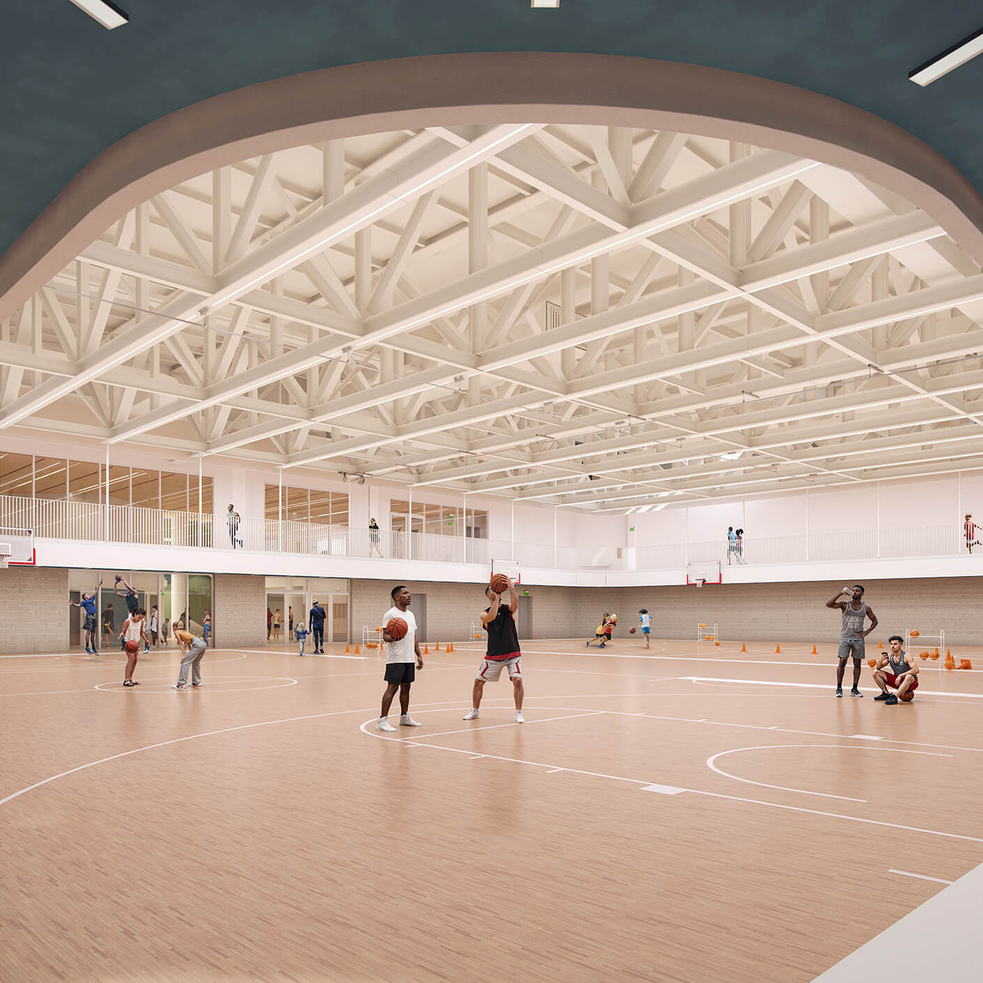 Indoor basketball court with players practicing and modern lighting fixtures.