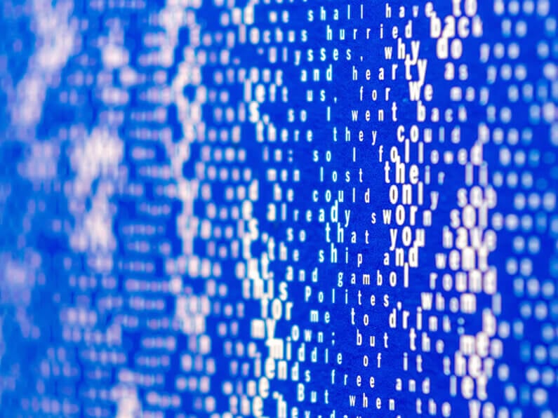Abstract text on a blue background, creating a visually striking and artistic effect.