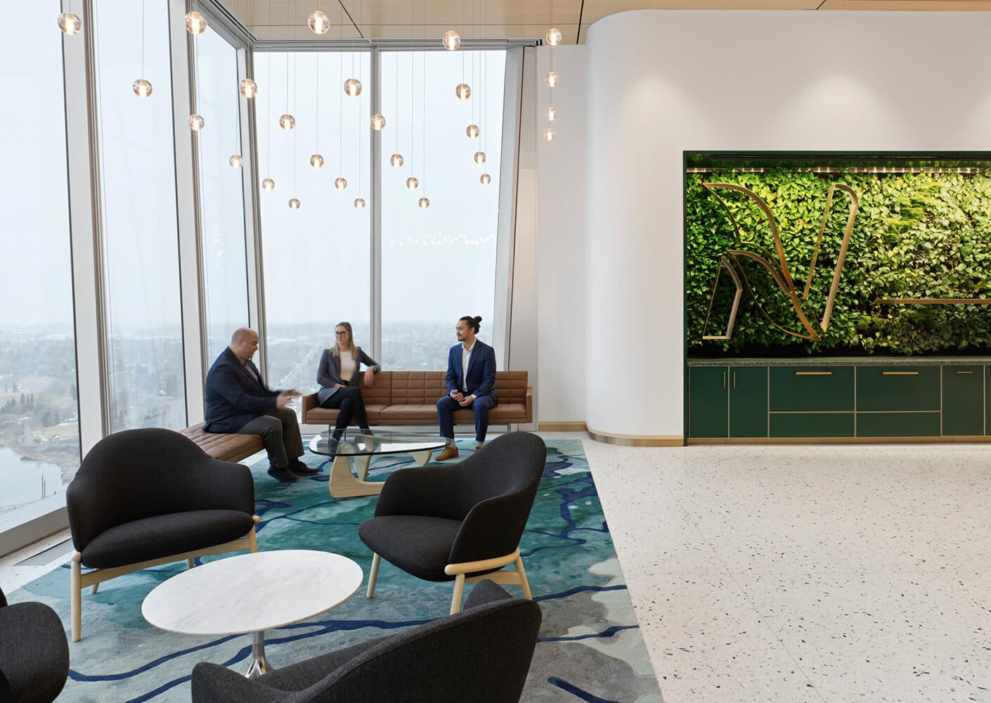 A spacious office lounge with large windows, featuring three professionals discussing ideas near a greenery wall and stylish furniture.