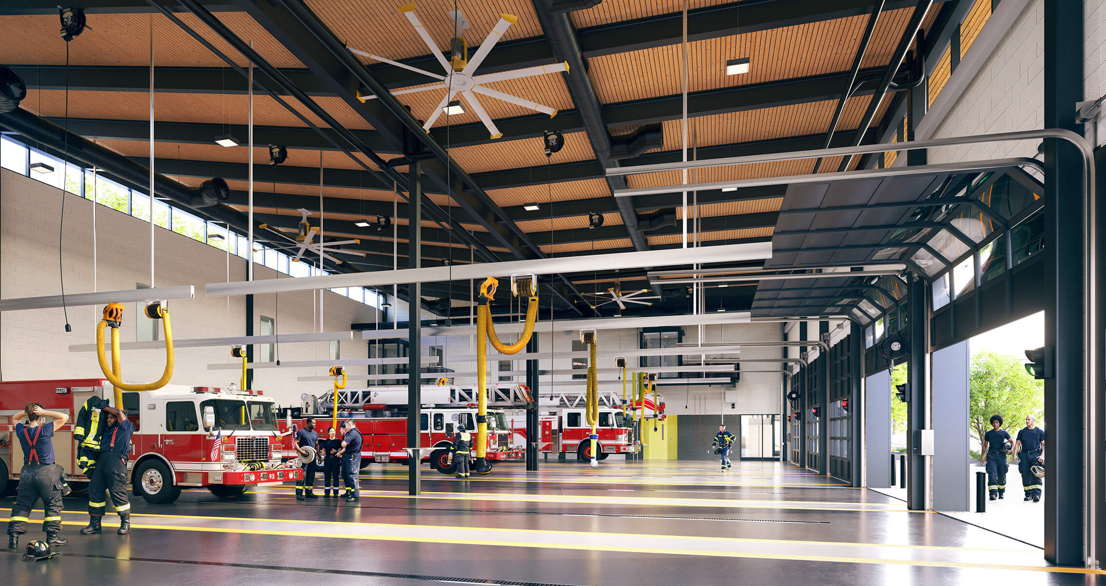 Fire station interior featuring fire trucks, firefighters preparing for duty, and large ceiling fans for ventilation and comfort.