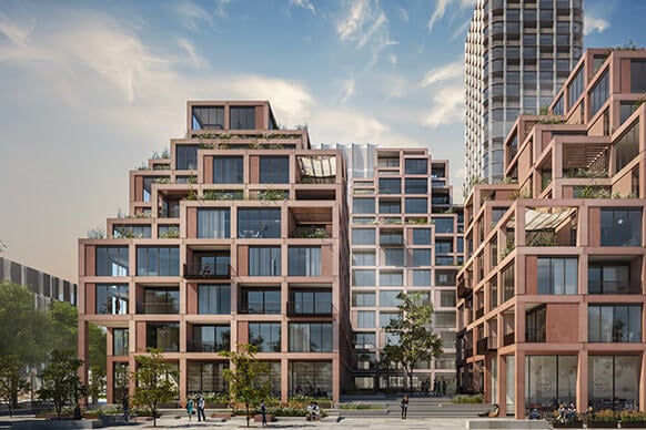 Residential building complex featuring multiple levels, large windows, terraces, and landscaping. Urban setting with people and trees visible.