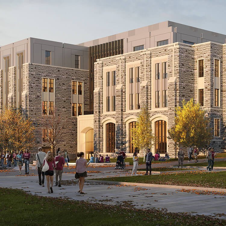 Students and visitors walk through a campus area with trees and pathways, featuring a stone building in the background.